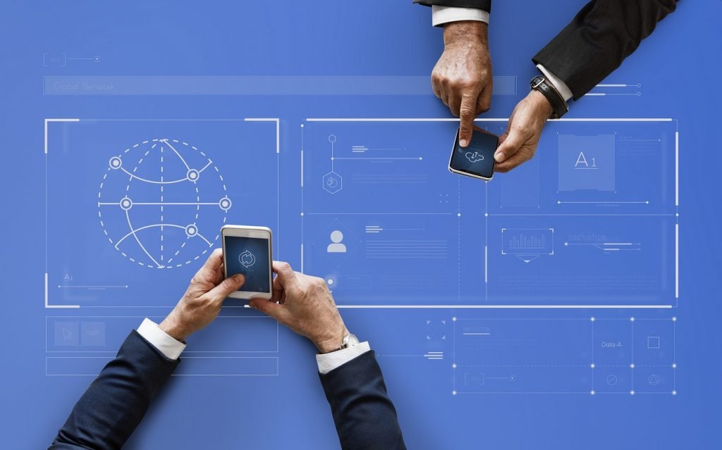 Business people syncing data by mobile phones